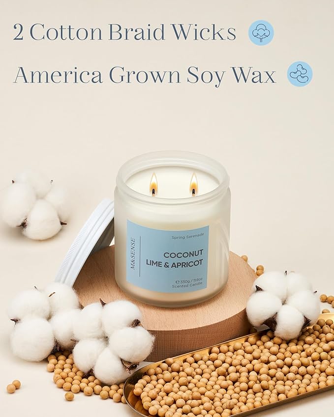 Candle with 'Coconut Lime & Apricot' label on a wooden coaster surrounded by cotton and beans, with text about cotton braid wicks and American grown soy wax.