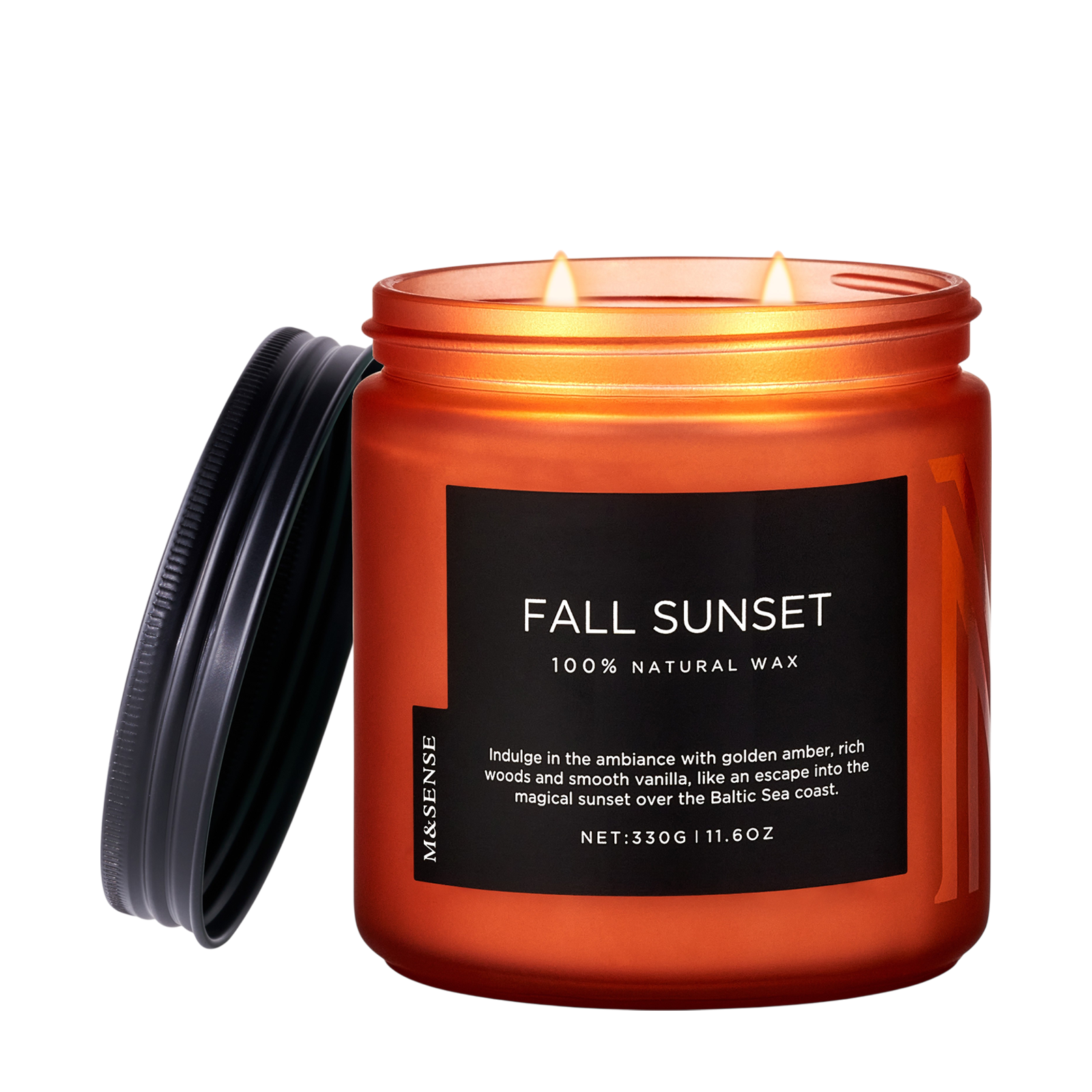 Orange candle labeled 'Fall Sunset' with a black lid on a white background