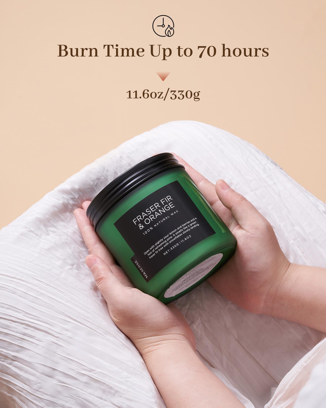 Green candle with black lid held by hands on a beige background, featuring text about burn time and weight.