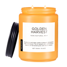 Orange candle jar labeled 'Golden Harvest' with a black lid on a white background