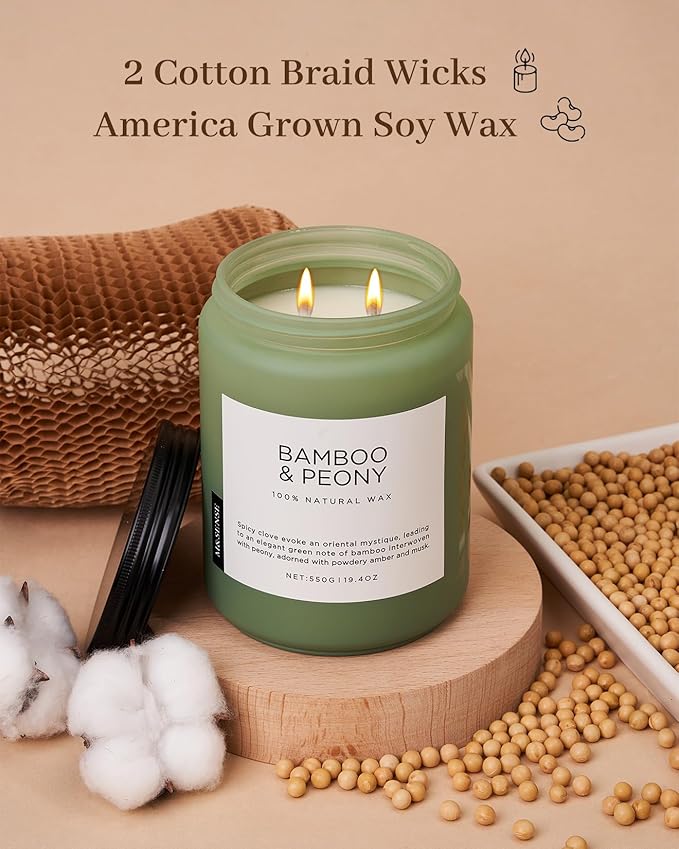 Green candle labeled 'Bamboo & Peony' with cotton braid wicks and soy wax on a beige background