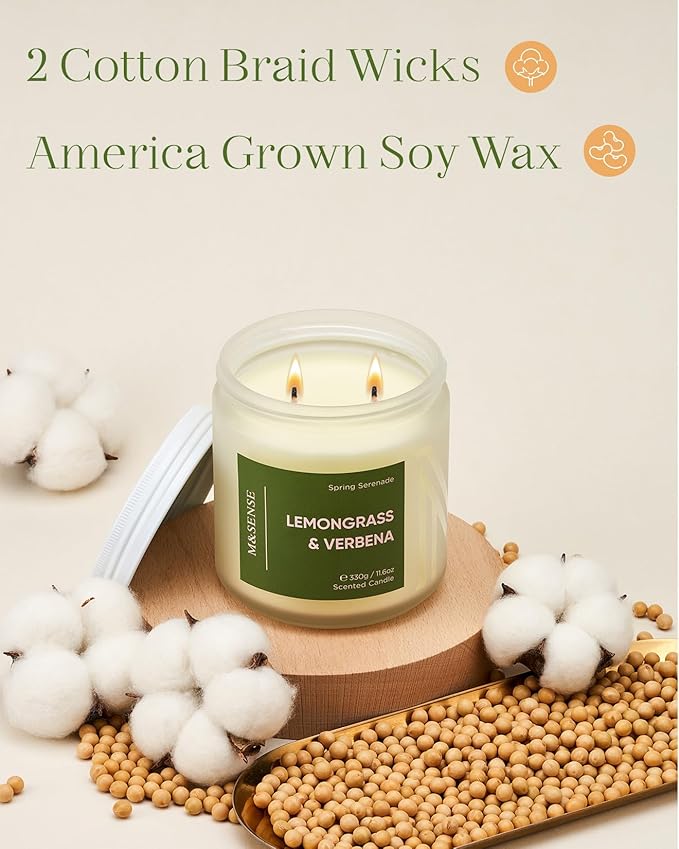 Candle with 'Lemongrass & Verbena' label on a wooden coaster surrounded by cotton and beans.