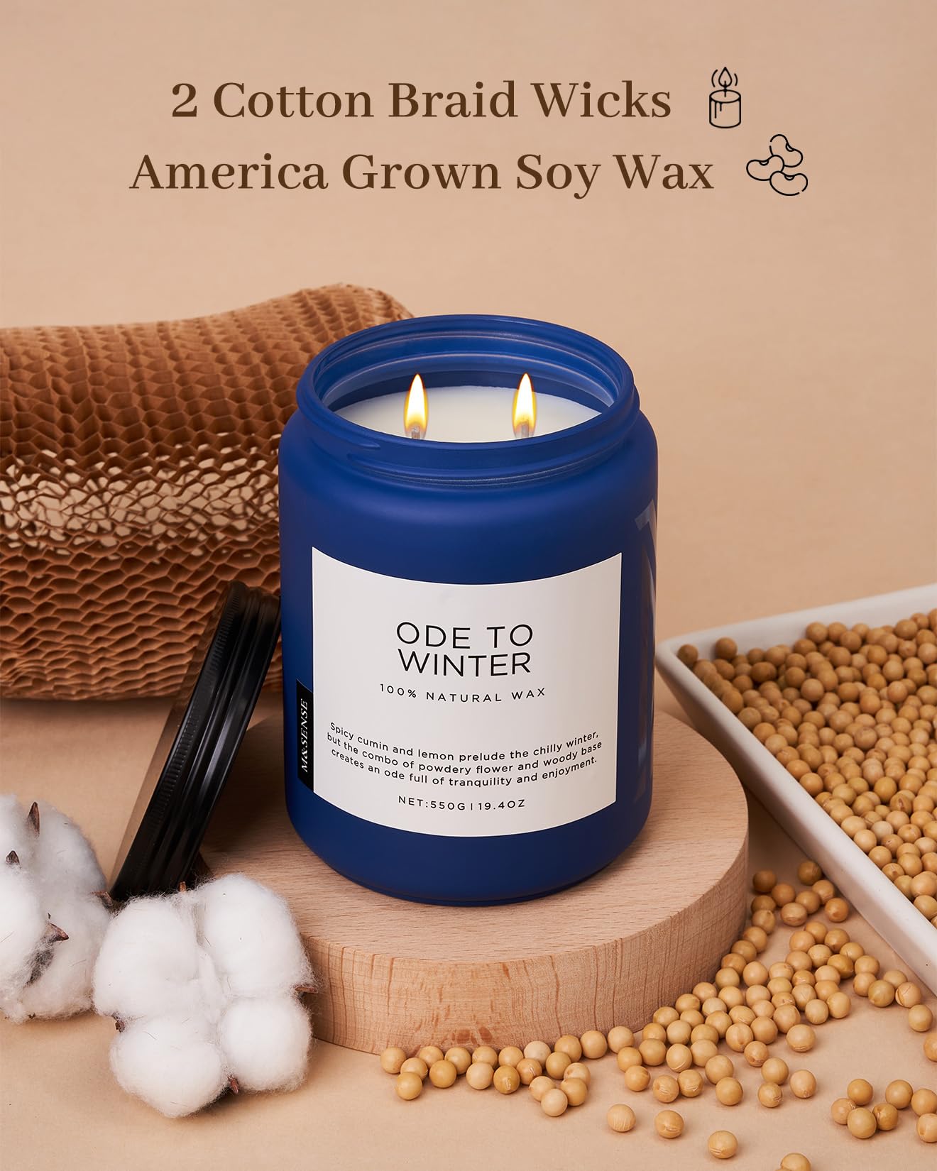 Candle with blue lid and white label on a wooden stand, surrounded by cotton and soybeans, with text about wicks and wax.