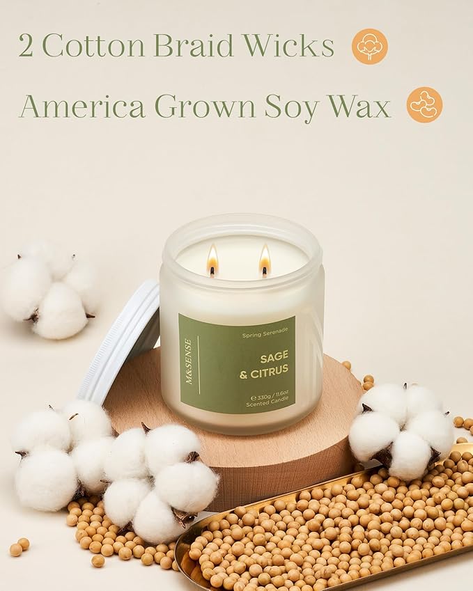 Candle with 'Sage & Citrus' label on a decorative surface with cotton and beans.