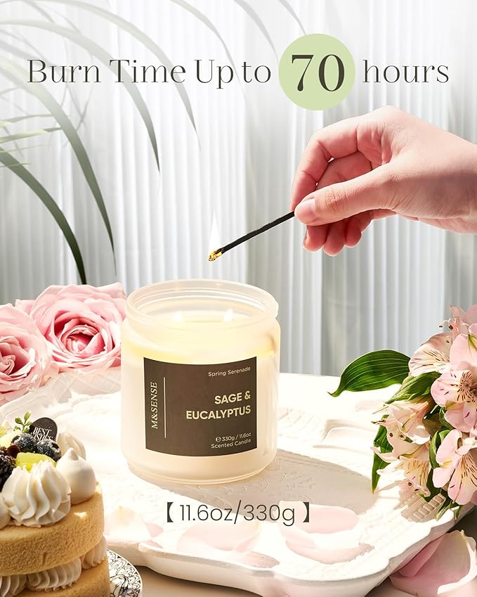 Candle with 'Sage & Eucalyptus' label being lit by a hand, surrounded by flowers and cake.