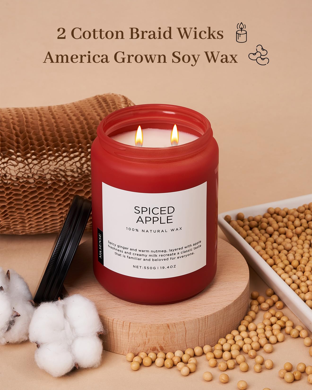 Red candle labeled 'Spiced Apple' with cotton braid wicks and soy wax on a beige background