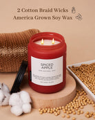 Red candle labeled 'Spiced Apple' with cotton braid wicks and soy wax on a beige background