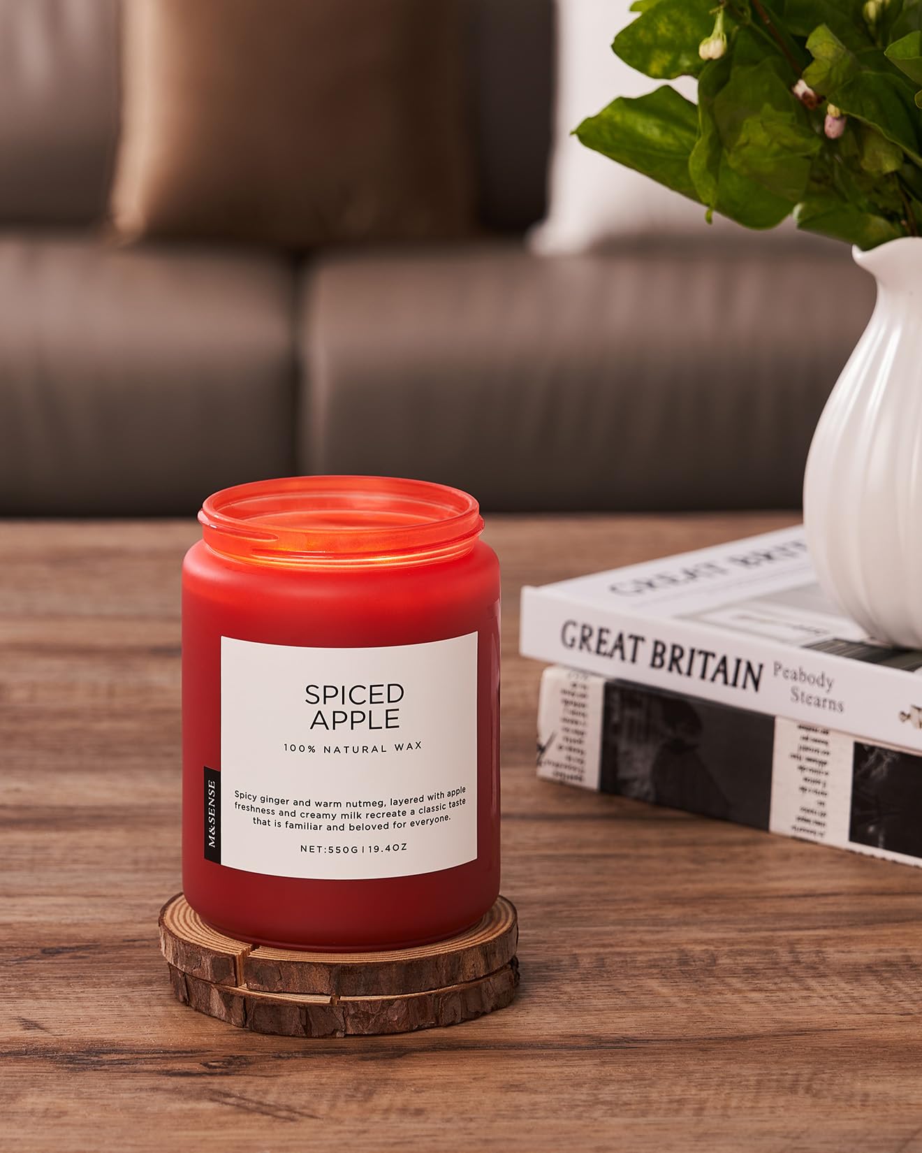 Spiced Apple candle on a wooden coaster with a blurred background